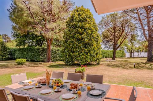 a table with food on it in a garden at Large lakeside villa in Lesa