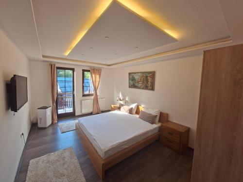 a bedroom with a bed and a tv in it at Vila Rakovica Ilidža Sarajevo in Sarajevo