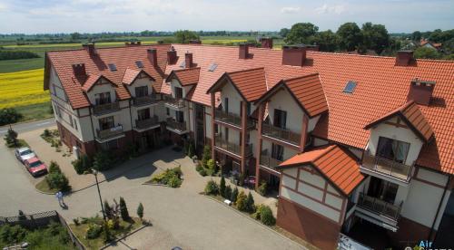 an overhead view of a large house with an orange roof at Lazurowy Dwor in Sztutowo