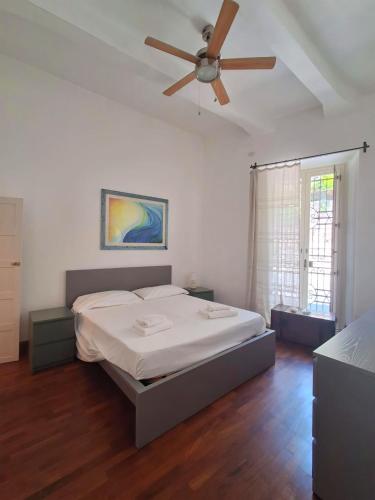 a bedroom with a bed and a ceiling fan at Casa Angioletta in Taormina