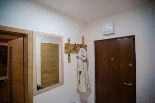 a bathroom with a door and a towel hanging on the wall at Orange stan in Žabljak