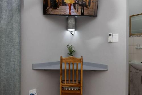a counter in a bathroom with a picture on the wall at Santa Stay in Stellenbosch