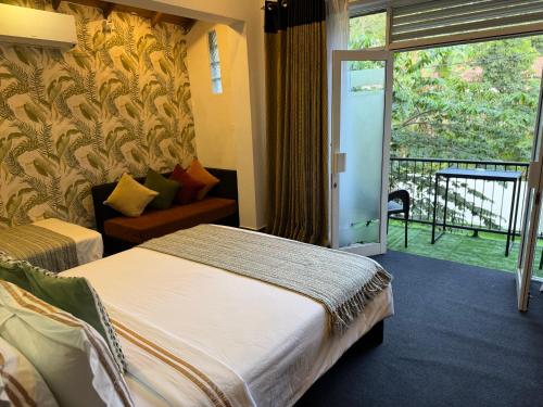 a hotel room with a bed and a sliding glass door at Ella moon rock in Ella