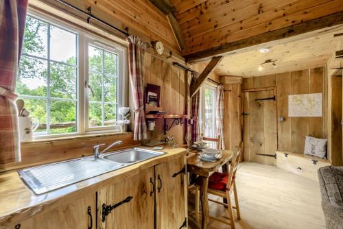 a kitchen with a sink and a table at 1 Bed in Chulmleigh oc-74133 in Eggesford