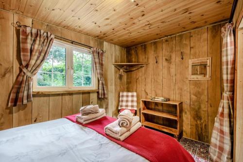 a bedroom with a bed with towels on it at 1 Bed in Chulmleigh oc-74133 in Eggesford