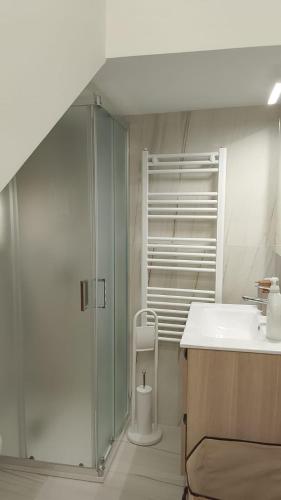 a bathroom with a glass shower and a sink at House Mare Blu in Balestrate