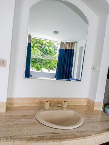 a bathroom with a sink and a mirror at Regency Plaza Hotel in Pisco