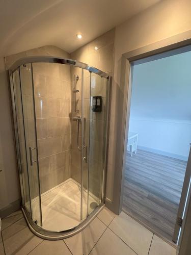 a shower in a bathroom with a view of the ocean at Lar Na Cluaine in Kilmurry