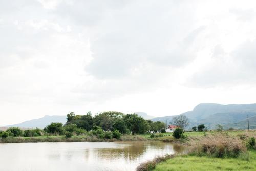 a view of a river with mountains in the background at The Cowshed in Lydenburg