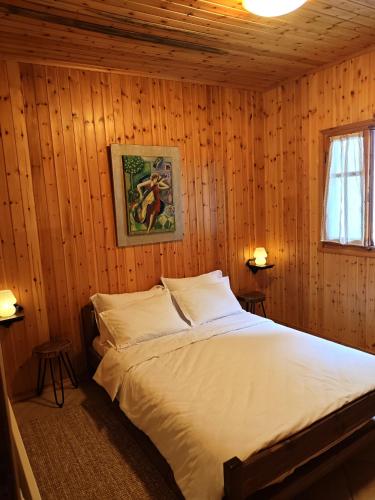 a bedroom with a bed in a wooden room at Mountain Nook Melissourgoi in Melissourgoí