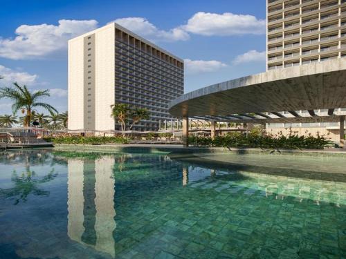 a large pool of water in front of a building at Apartamento Beach Resort in Salinópolis