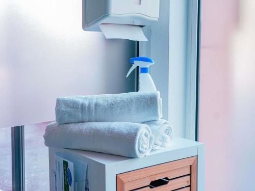 a pile of towels on a table in a bathroom at ibis Martigues Centre in Martigues