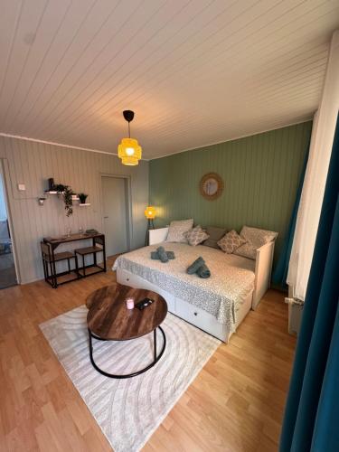 a bedroom with a bed and a table at Écrin de barr in Barr
