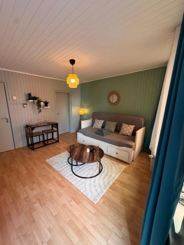 a living room with a couch and a coffee table at Écrin de barr in Barr