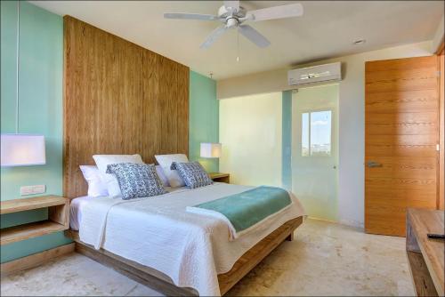 a bedroom with a bed and a ceiling fan at Anah Suites by Las Flores Vacation Rentals in Playa del Carmen