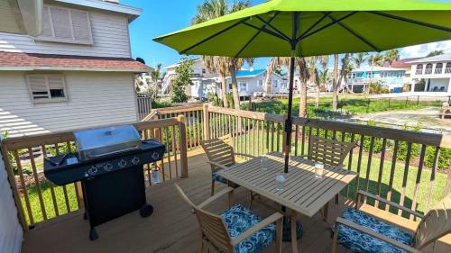 a grill and picnic table on a deck with a bbq at 213 Ohio in Fort Myers Beach