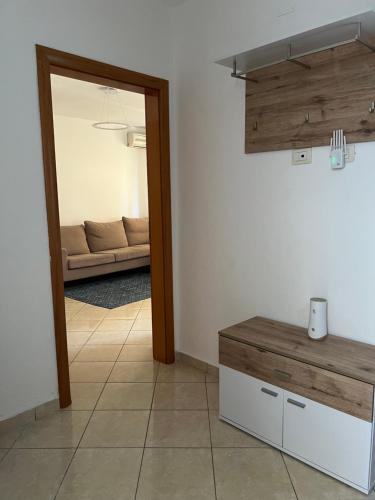 a living room with a couch and a mirror at Grediv Apartment Orikum in Orikum