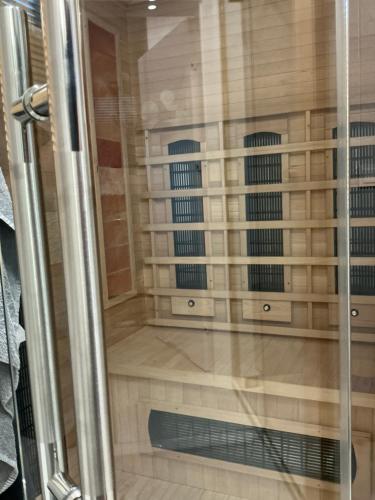 a shower with a glass door in a bathroom at Sarbinowo Lazur Spokojna in Sarbinowo