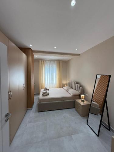 a bedroom with a large bed and a window at Coastal dreams Golem in Golem