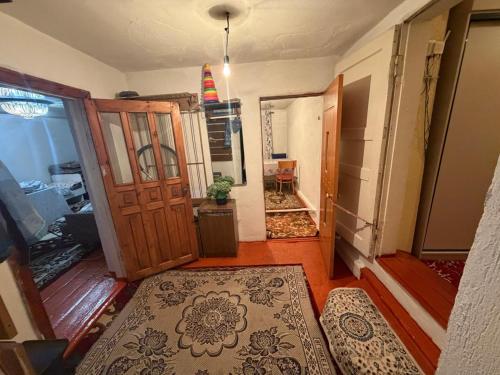 a room with a door and a hallway with a rug at NurNomad 2 in Balykchy