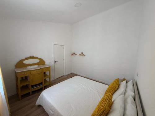 a small bedroom with a bed and a desk at Casa Vila de Frades in Vila de Frades