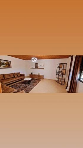 a living room with a couch and a table at Casa in Durrës