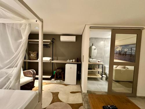 a bedroom with a bed with a mirror and a desk at Inn Tribus Hotel in Flecheiras