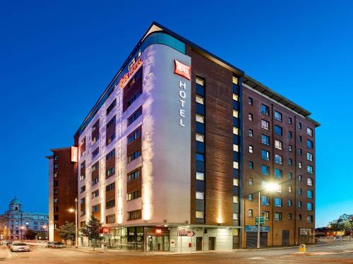 a building with a sign on the side of it at ibis Belfast City Centre in Belfast