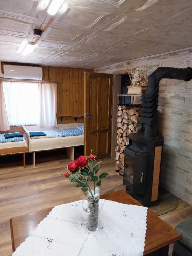 a living room with a table and a wood stove at Chata v lese in Olbramkostel