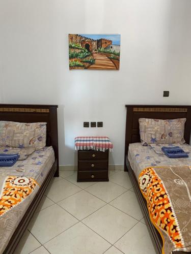 two beds sitting next to each other in a bedroom at TANJALUCIA HOSTeL in Tangier