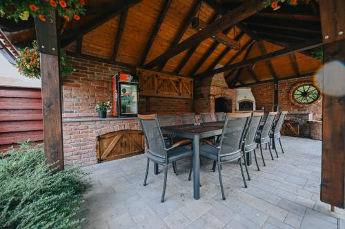 a patio with a table and chairs in a building at Grádics Panzió in Siculeni