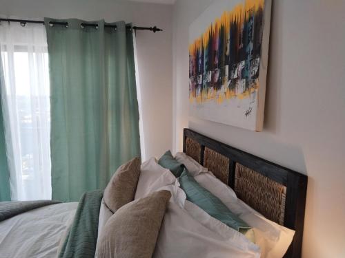 a bedroom with a bed with a green curtain at Aurevia Properties in Pretoria