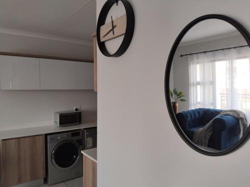 a mirror hanging on a wall in a kitchen at Aurevia Properties in Pretoria