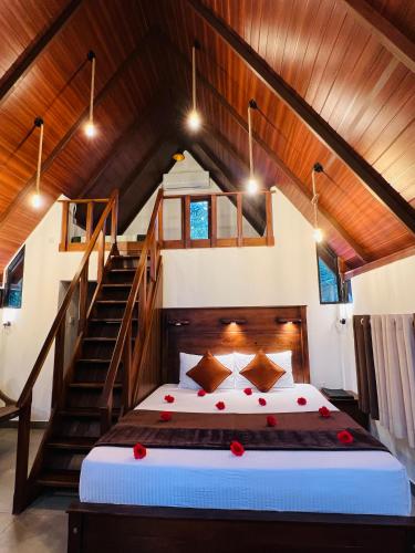 a bedroom with a bed in a room with stairs at Coffee Cabanas in Matale
