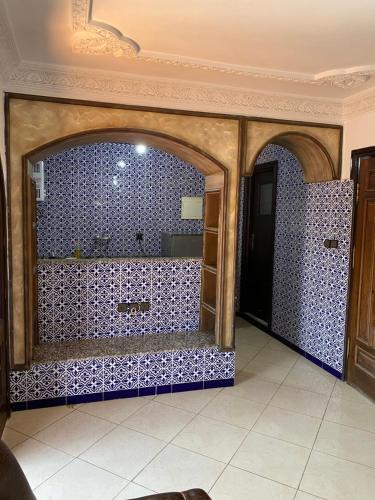 a bathroom with blue tiled walls and a shower at TANJALUCIA HOSTeL in Tangier