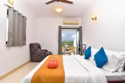 a bedroom with a large bed and a chair at Diamond Villa - The Dream Stays ll Pvt Pool ll Wi-Fi ll 2AC Rooms in Lonavala