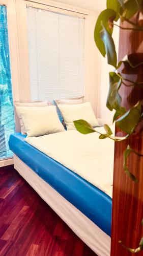 a bed in a room with a large window at Lanas place in Ljubljana
