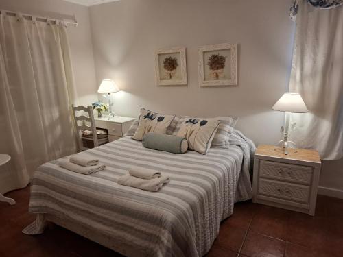 a bedroom with a bed with two towels on it at Casa La Bendición in Mar del Plata
