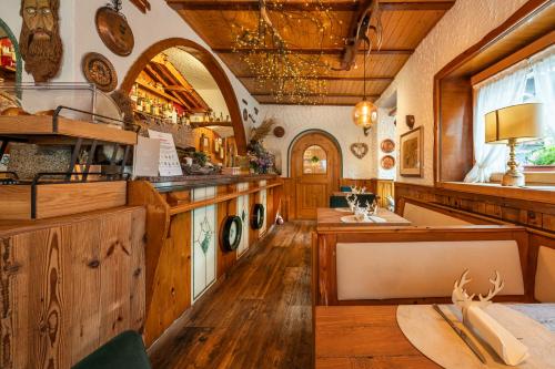 a kitchen with wooden floors and a counter with a sink at Hotel Garnì La Montanara in Madonna di Campiglio