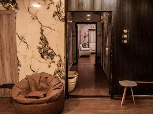 a living room with a chair and a hallway at Miracle Pyramids View Hotel in Giza