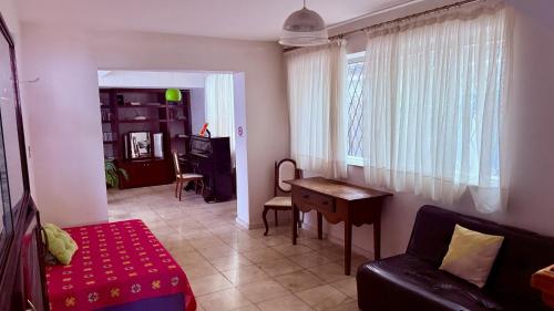 a living room with a couch and a table at Vila Santê in Belo Horizonte