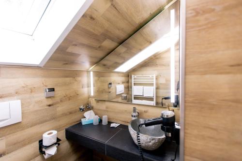 a bathroom with a sink and a mirror at Hotel Anneliese in Bad Hindelang