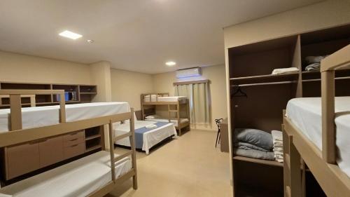 a room with two bunk beds and a hallway at Hotel da Vila in Vila Bela da Santíssima Trindade