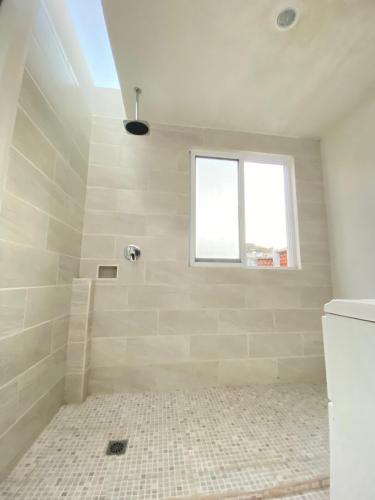 a white bathroom with a shower with a window at Galerie Guanajuato Centro in Guanajuato
