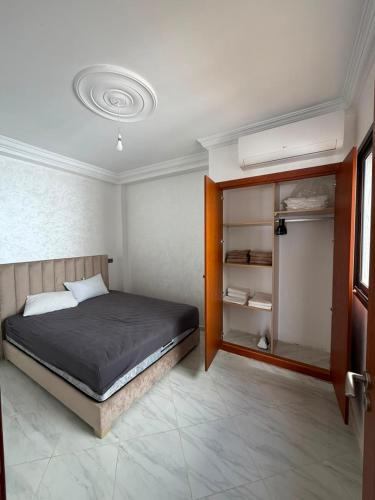 a bedroom with a bed and a book shelf at Mini Villa Azur - Bord de Mer in Driouch