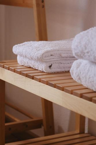 a pile of towels sitting on top of a shelf at Douro Feels Like Home in Fontelo