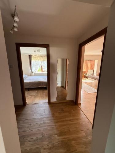 a hallway with a mirror and a bedroom at Rose Cozy in Snagov