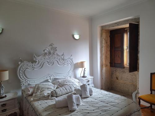 a bedroom with a white bed with towels on it at Quinta das Carvalhas in Neiva