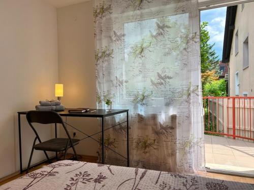 a room with a desk and a window with a curtain at Spacious Rooms Near Center in Ljubljana