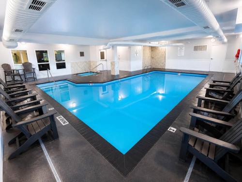 a large swimming pool with chairs around it at Quality Inn & Suites Sequim at Olympic National Park in Sequim